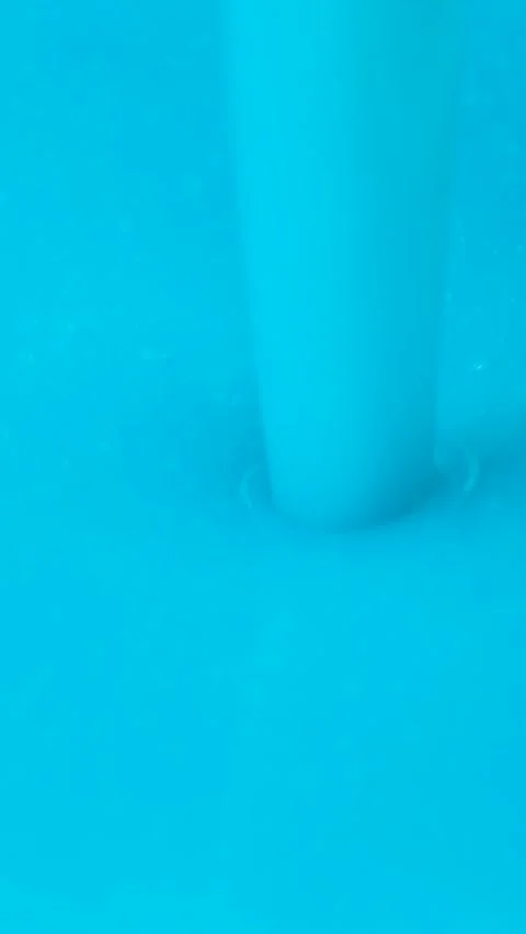 Slow motion macro shot of thick blue liquid laundry detergent pouring. Stock Footage 337561415