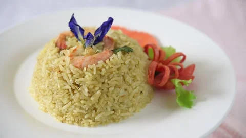 Slow motion macro of shrimp fried basil rice on a white plate Stock Footage 160564531