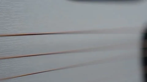 Slow Motion Macro of Third Guitar String Vibrating Stock Footage 330119719