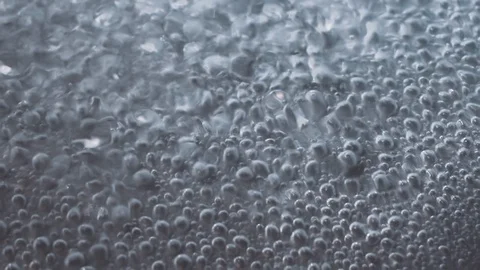 Slow motion macro video of air bubbles in boiling water Stock Footage 104788902