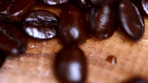 Slow motion Macro video of coffee beans pouring on to a wooden surface 動画素材 149285578