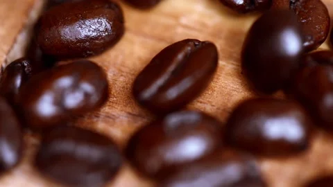 Slow motion Macro video of coffee beans pouring on to a wooden surface Stock-Footage 149285585