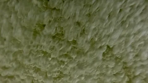 Slow motion macro view of air bubbles underwater with camera surfacing and .. Stock Footage 334315759