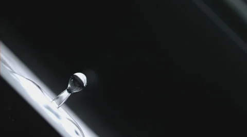 Slow motion, macro of water drop splashing and creating sparkling water drops Stock Footage 63846077