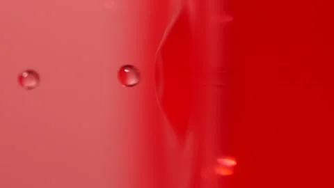 Slow motion of macro water drop falling into pink water, closeup droplet splash Stock Footage 195078819