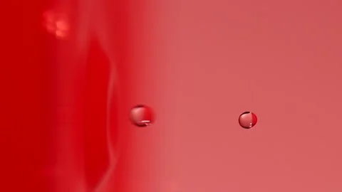 Slow motion of macro water drop falling into pink water, closeup droplet splash Stock Footage 196966384