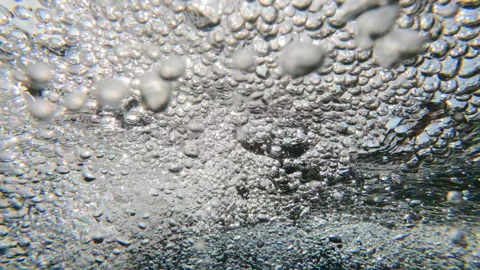 Slow motion macro: wild dance of aerated bubbles trapped under turbulent surface Stock Footage 341281529