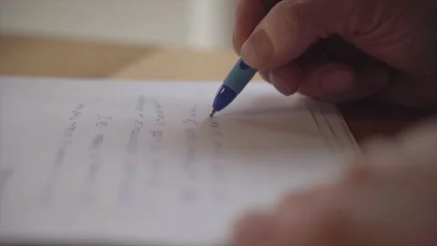 Slow motion macro writing with a blue pen Stock Footage 148091883