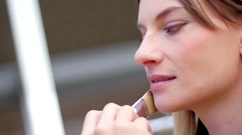 Slow motion of a makeup artist correcting models makeup Stock Footage 59738159