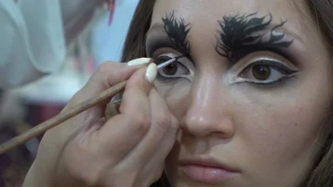 Slow Motion Makeup artist creating beautiful makeup for brunette model Stock Footage 165540478