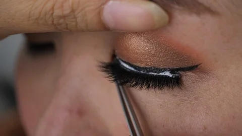 Slow motion, makeup beauty paste long false eyelash on eye Stock Footage 92079149