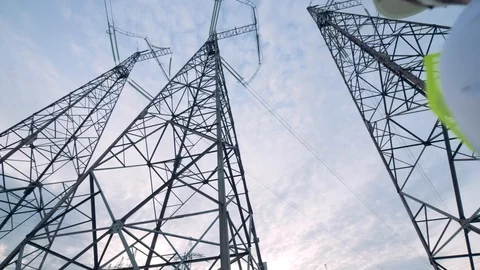Slow motion of a male engineer working with a tablet near power lines Stock Footage 101200454