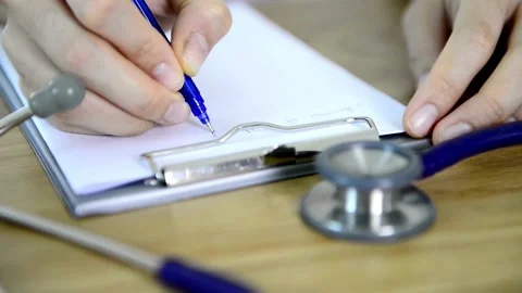 Slow motion. Male physicians hand writing rx prescription doctor in the Stock-Footage 336587712