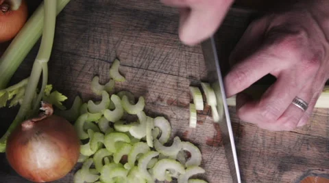 Slow motion of a male's hands chopping celery Stock Footage 57234623