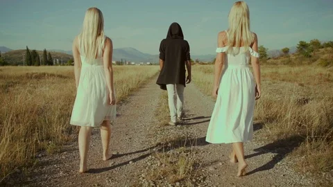 Slow Motion! A man and two girls are on a dirt road. Stock Footage 117545257
