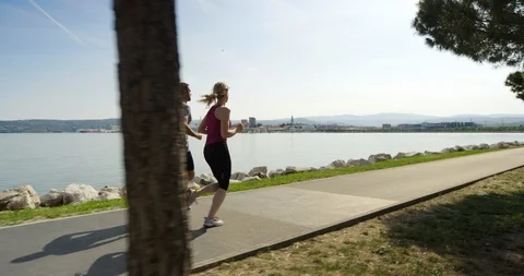 Slow Motion Of Man And Woman Chatting While Running Stock Footage 123712718