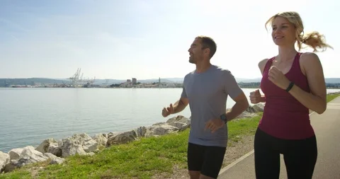 Slow Motion Of Man And Woman Enjoying Their Morning Run Stock Footage 123733606