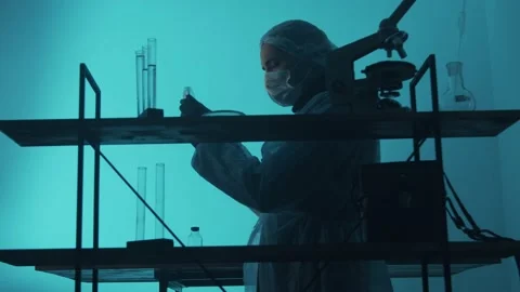 Slow motion. A man of Arab appearance Laboratory researcher rearranges samples i Stock Footage 233030689