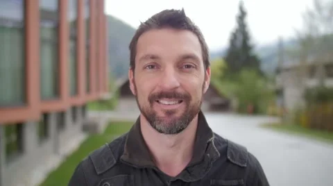 Slow motion of a man with beard smiling in camera Video stock 49752665