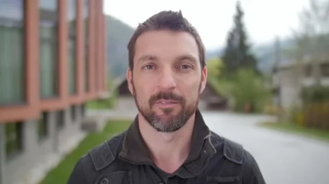 Slow motion of a man with beard watching serious in camera Stock Footage 49752557