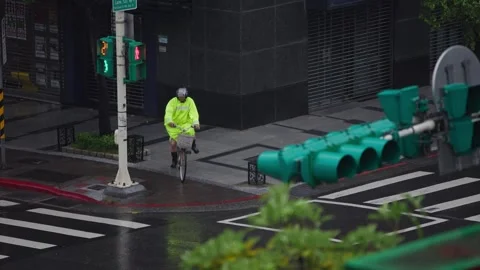 Slow motion of man on bicycle riding through flooded street in Taipei Stock Footage 314017770