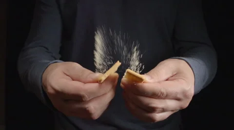 SLOW MOTION: Man breaks a cookie by a hands Stock Footage 68686971