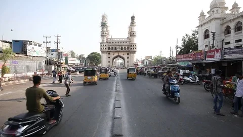 Slow motion man crossing road front of Charminar Stock Footage 74759526