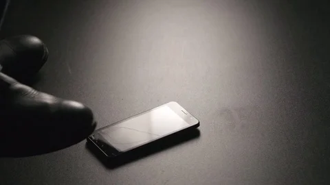 SLOW MOTION: Man crushes a smartphone on a floor by a boot Video stock 72374676