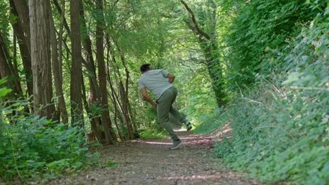 Slow motion. A man diligently practices various martial arts techniques while Stock Footage 311448080