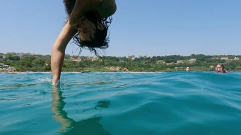 Slow motion of man diving in turquoise sea Stock Footage 277547525