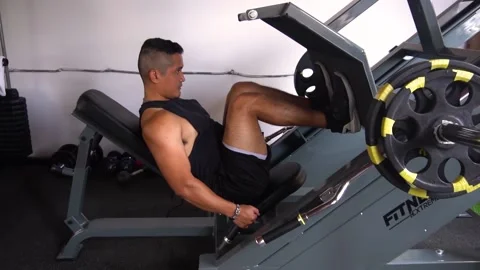Slow motion of a man doing an incline leg press exercise Stock Footage 146505835