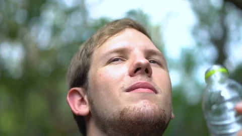 Slow Motion - Man Drinking Water From Bottle While Hiking Stock Footage 100216187