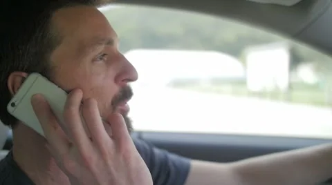 Slow motion of a man driving and talking over phone Stock-Footage 49752282