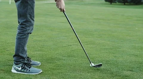 Slow motion of man driving a golf ball with his club Stock Footage 55141973