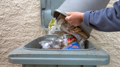 Slow motion: Man emptying bin / trash. Stock Footage 89716995