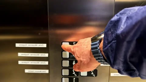 Slow motion of man entering modern steel elevator and pressing floor button Stock Footage 336779755