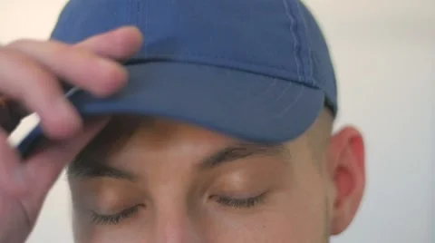Slow motion of a man eyes taking off a baseball hat Video stock 49788094