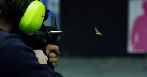 Slow motion man firing automatic machine gun Stock Footage 45976060