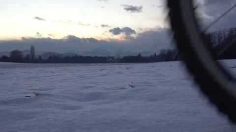 Slow motion of a man going by bike in the mountain countryside to The Alps, in Stock Footage 83428110