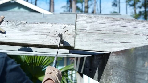 Slow motion of man hammering a beam of wood Video stock 124981972