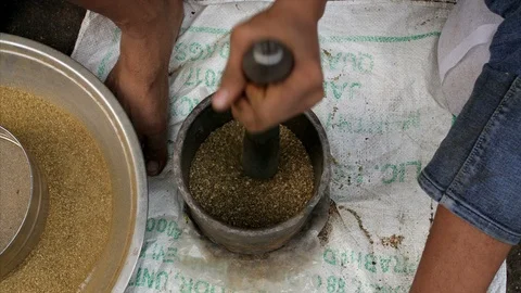 Slow motion of a man hand pounding raw spices in a stone mortar Stock Footage 112773184