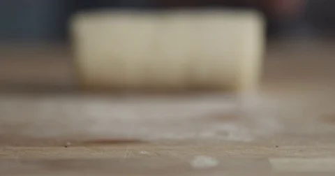 Slow motion of man hand roll a dough to a camera Stock Footage 75194358