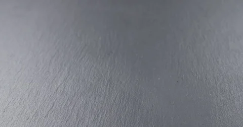 Slow motion of man hand stacking strawberry macarons on slate board Video stock 74023375