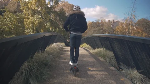 Slow Motion of Man with Helmet Using Electric Scooter on a Bridge 2 Vidéo 98758521
