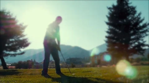 Slow motion of man hitting the golf ball on the golf course Stock Footage 54587667