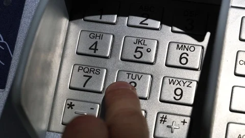 Slow motion, man input PIN code in ATM Stockbeeldmateriaal 119730122