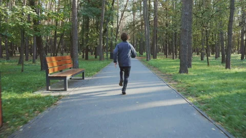 Slow motion man jogging in autumn park Stock Footage 218434840