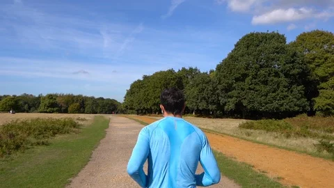 Slow Motion Man Jogging Away from Camera Stock Footage 96047480