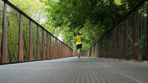 Slow motion man jogging on bridge Stock Footage 163512854