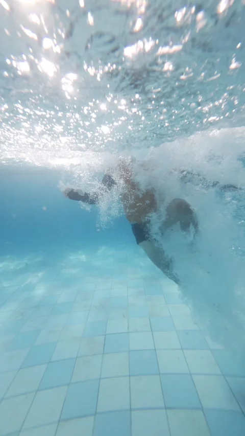 Slow motion of a man jumping into clear blue water Stock Footage 340535936